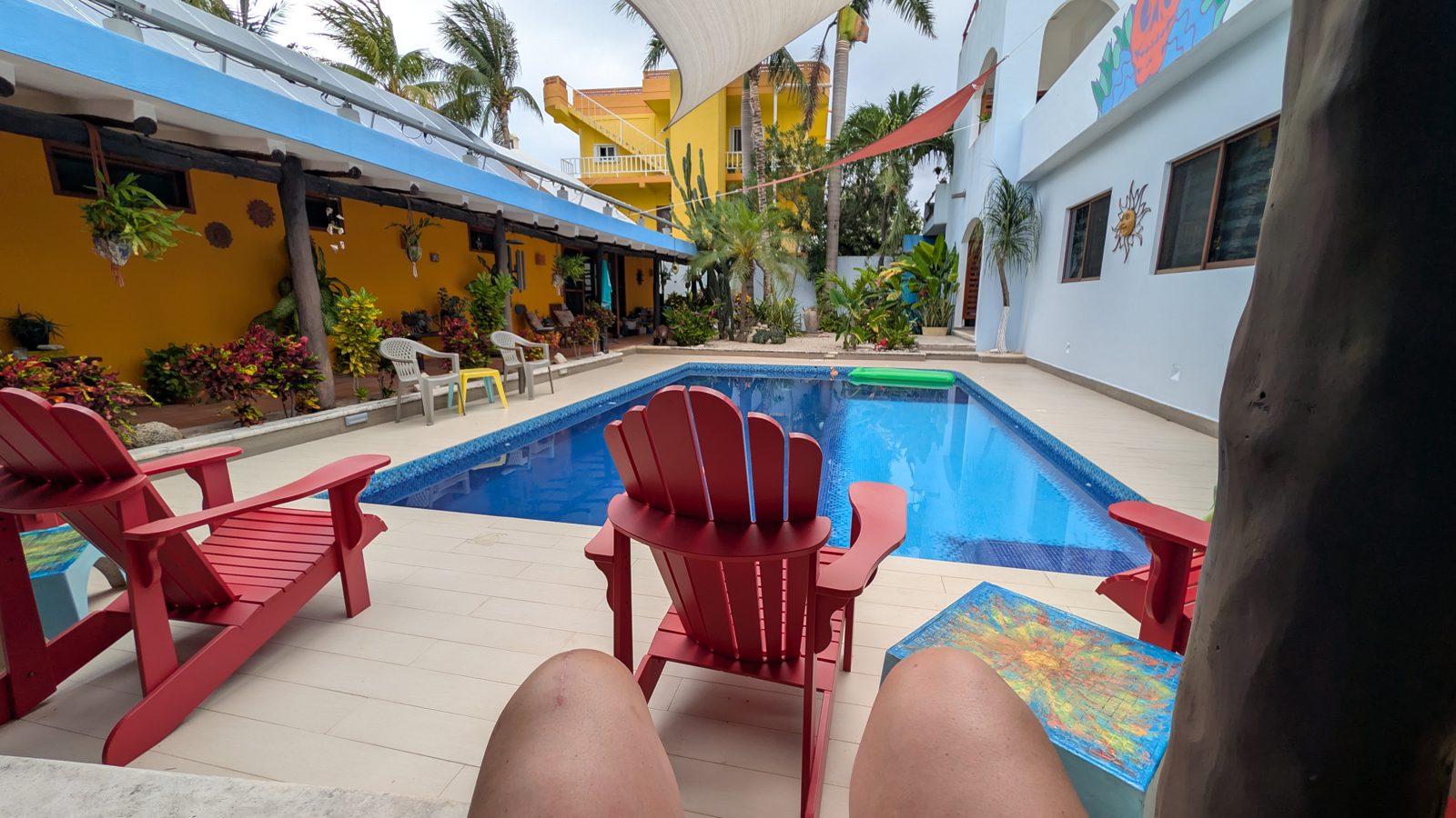 The pool and red chairs at sunset